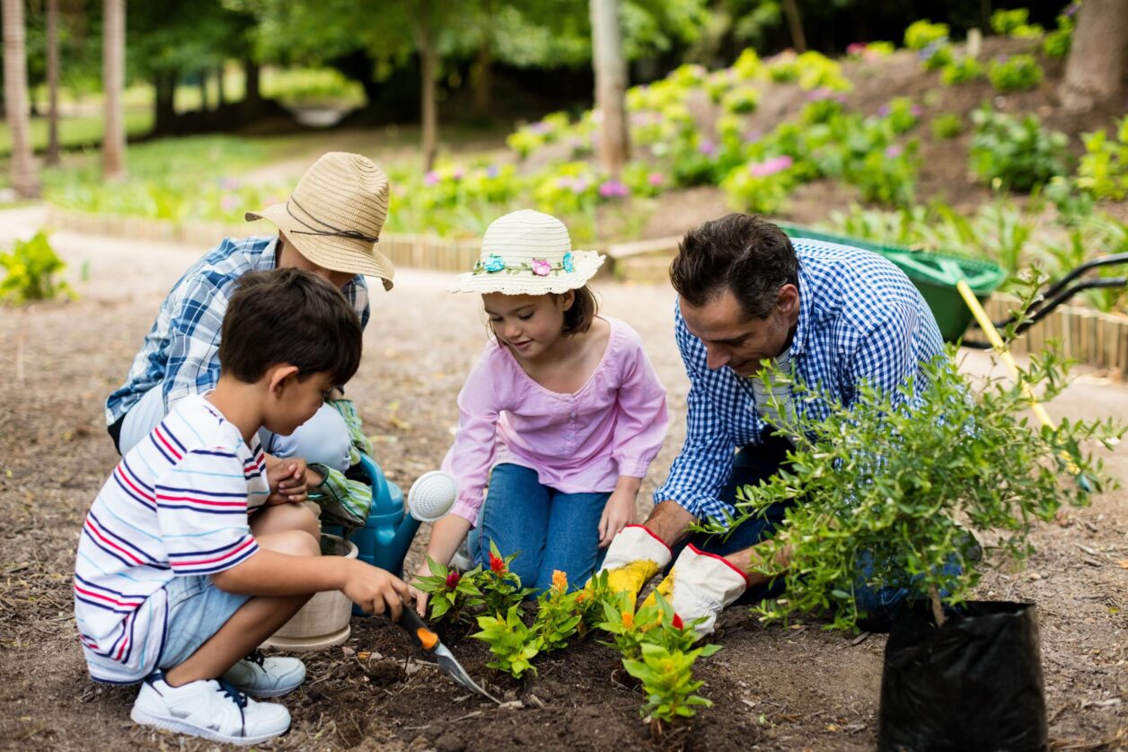 family planting flowers outside